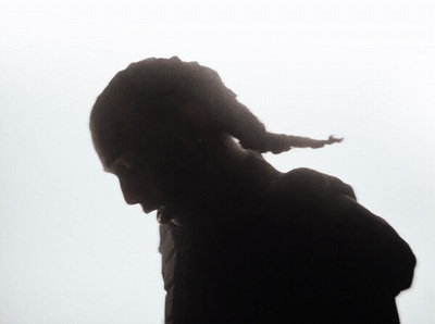 a silhouette of a person holding a cell phone to their ear