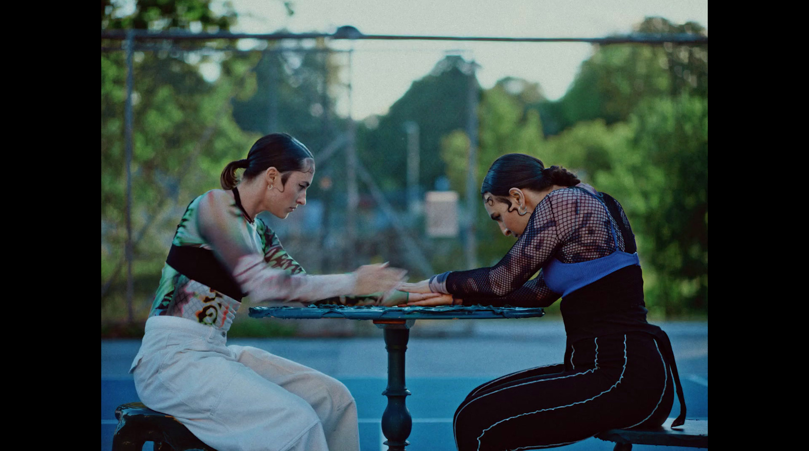 two women sitting at a table playing a game of chess