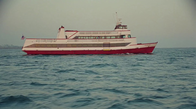 a red and white boat in the middle of the ocean