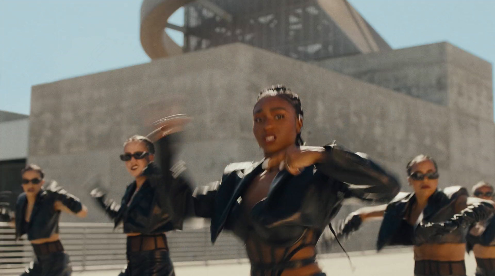 a group of women dressed in black dancing