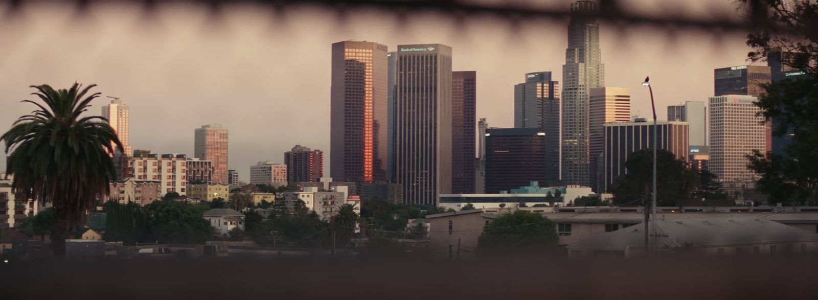 a view of a city from behind a fence