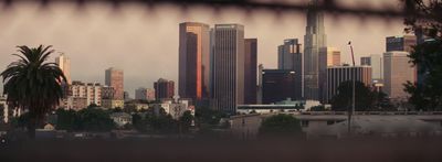 a view of a city from behind a fence