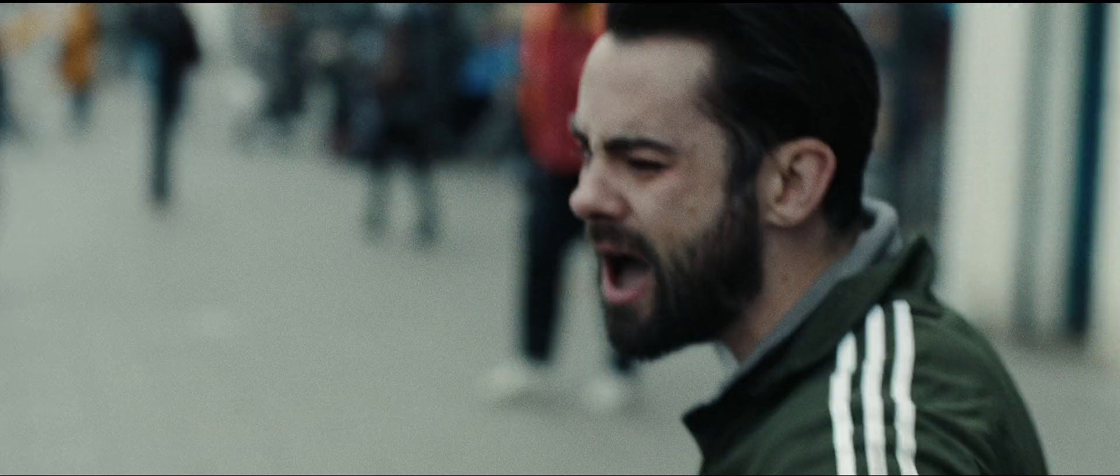 a man with a beard and a green jacket