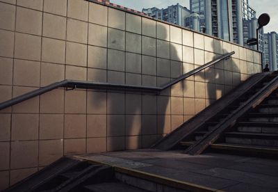 a shadow of a person on a wall next to a set of stairs