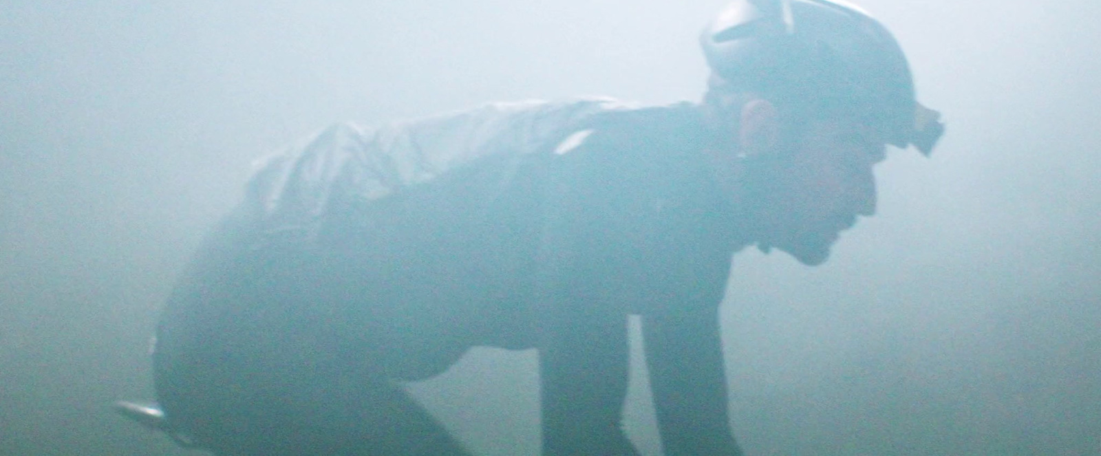 a man in a batman costume standing in the fog