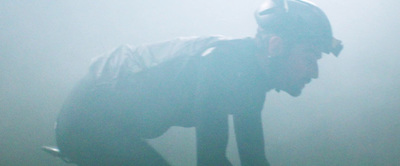 a man in a batman costume standing in the fog