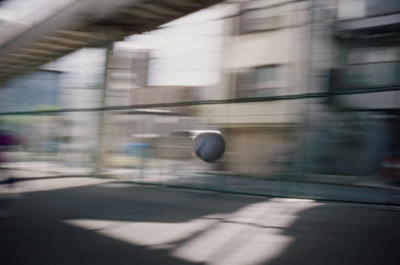 a blurry photo of a street with a building in the background