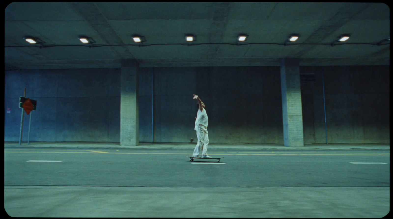 a person riding a skateboard in a parking garage