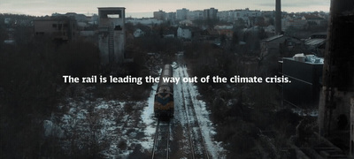 a train traveling through a city next to tall buildings