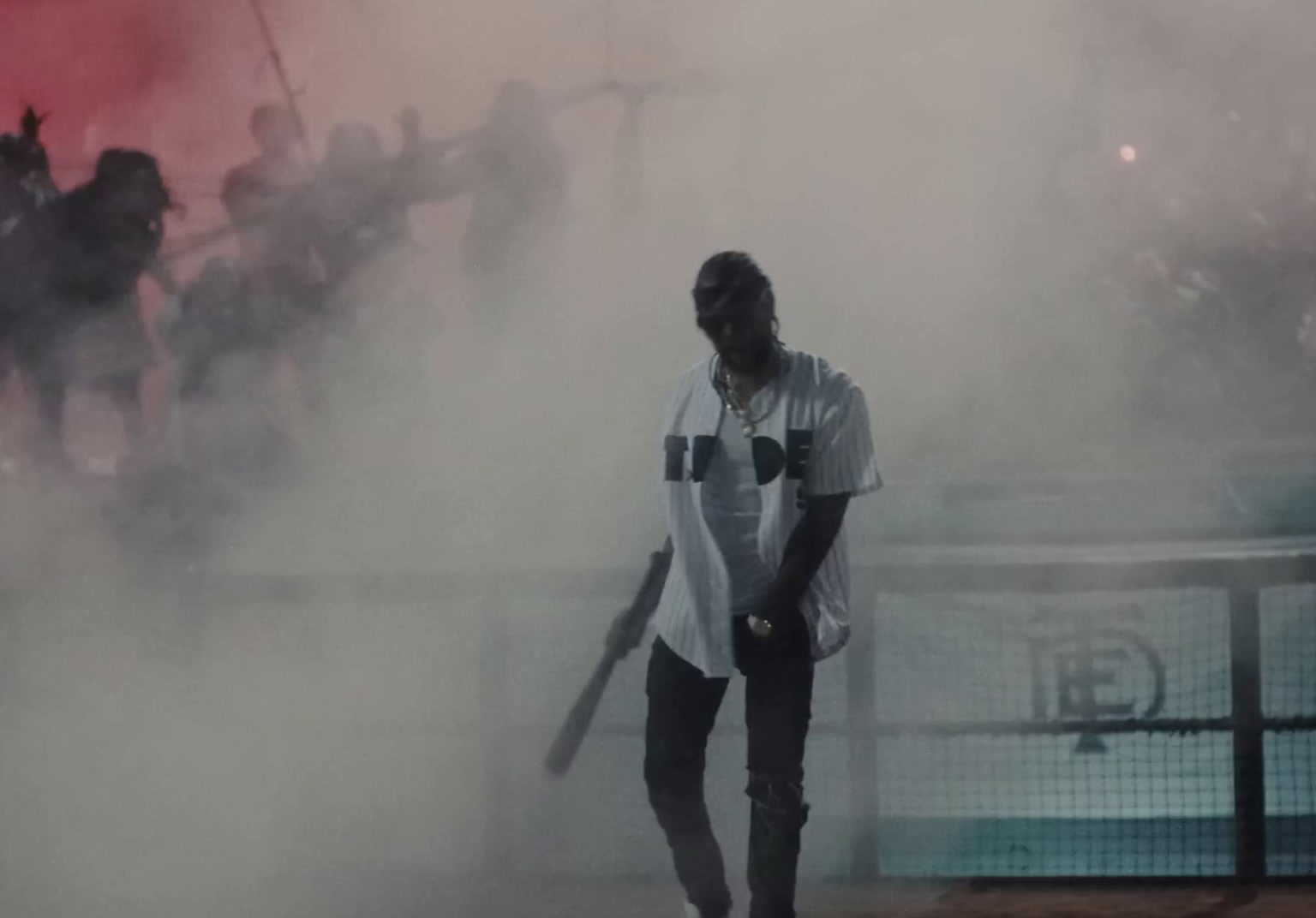 a man holding a baseball bat in front of a crowd of people