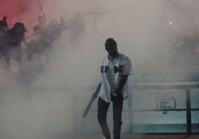 a man holding a baseball bat in front of a crowd of people