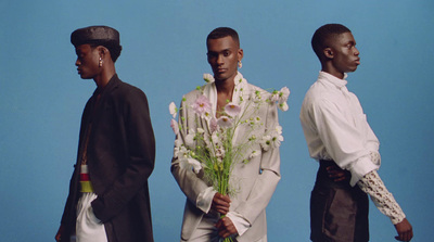 a group of three men standing next to each other