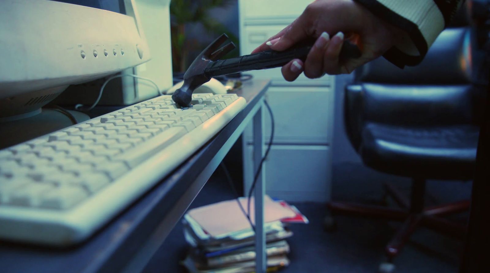 a person holding a piece of paper near a keyboard