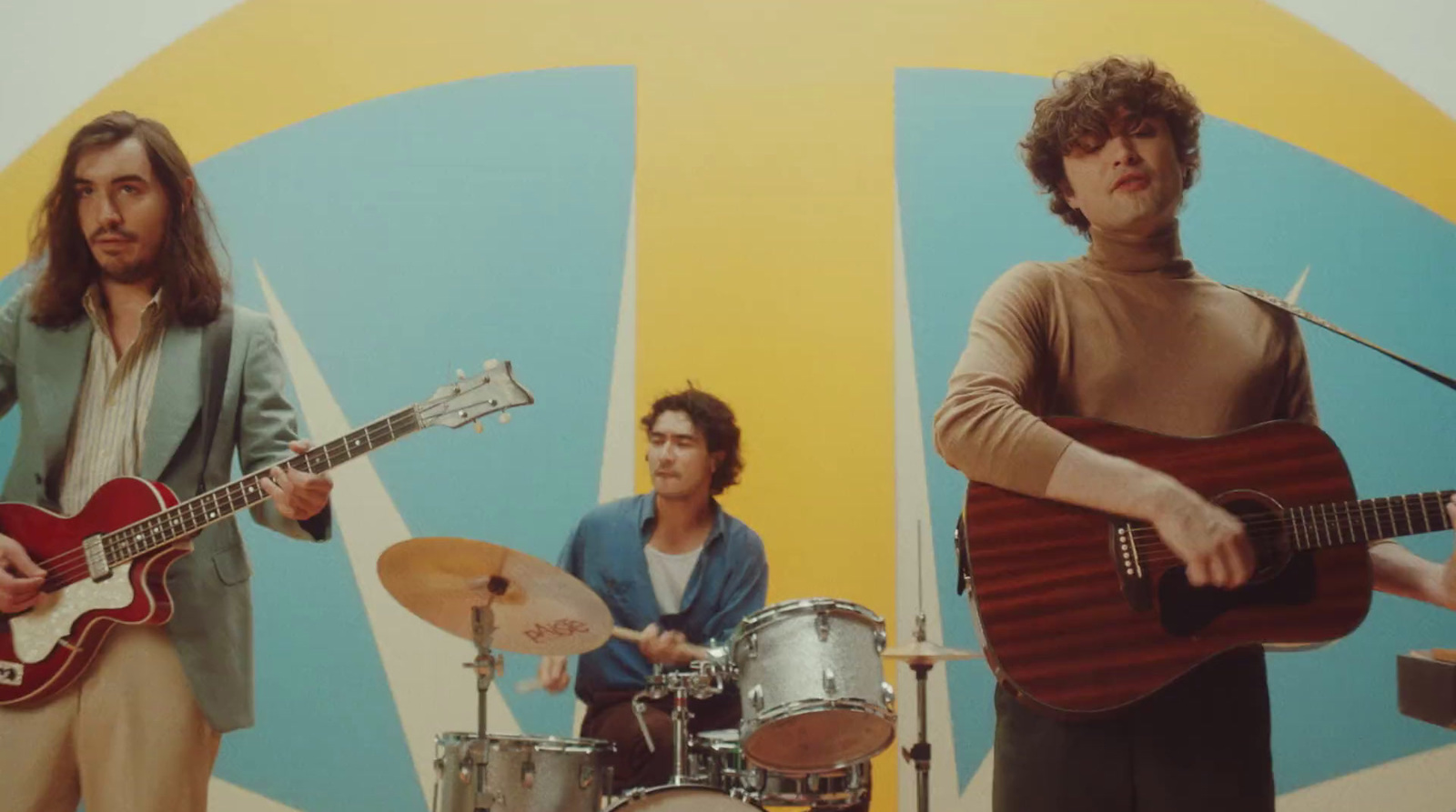 a group of men standing next to each other with guitars