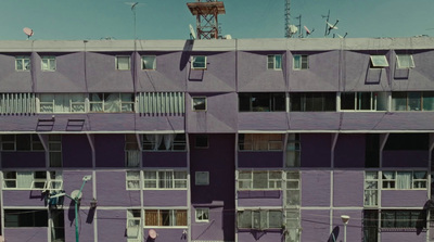 a tall purple building with lots of windows