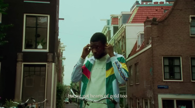 a man standing on a street talking on a cell phone