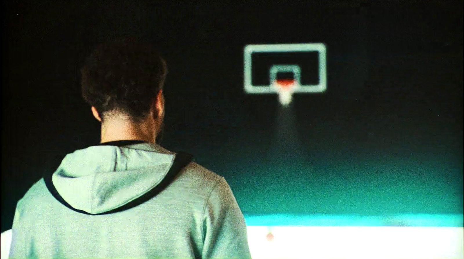 a man standing in front of a basketball hoop