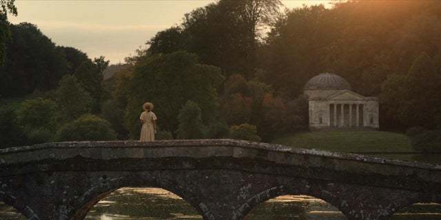 a person standing on a bridge over a body of water