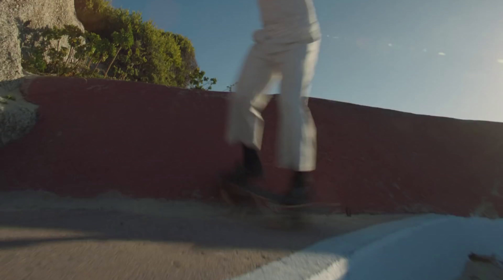 a person riding a skateboard down a hill