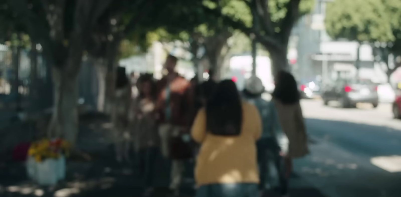 a blurry photo of people walking down a street