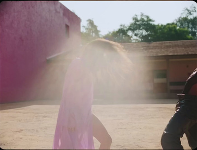 a man and a woman walking in the sand