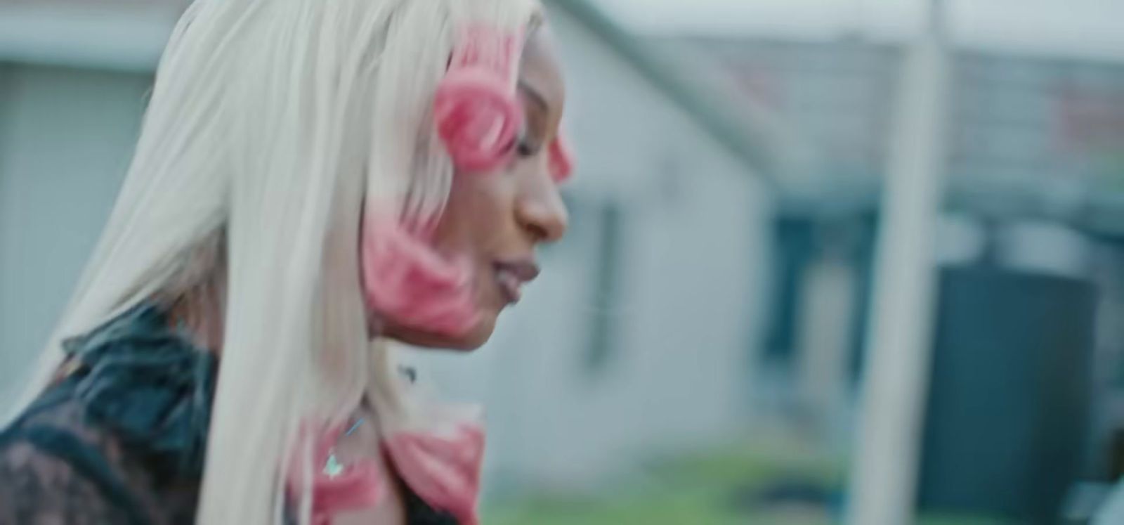 a woman with long white hair with pink circles on her face