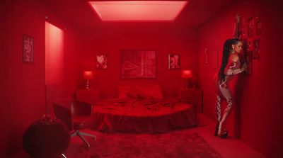 a red room with a bed and a red light