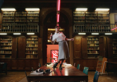 a woman standing on a table in a library