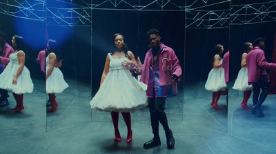 a man and a woman standing in front of a mirror