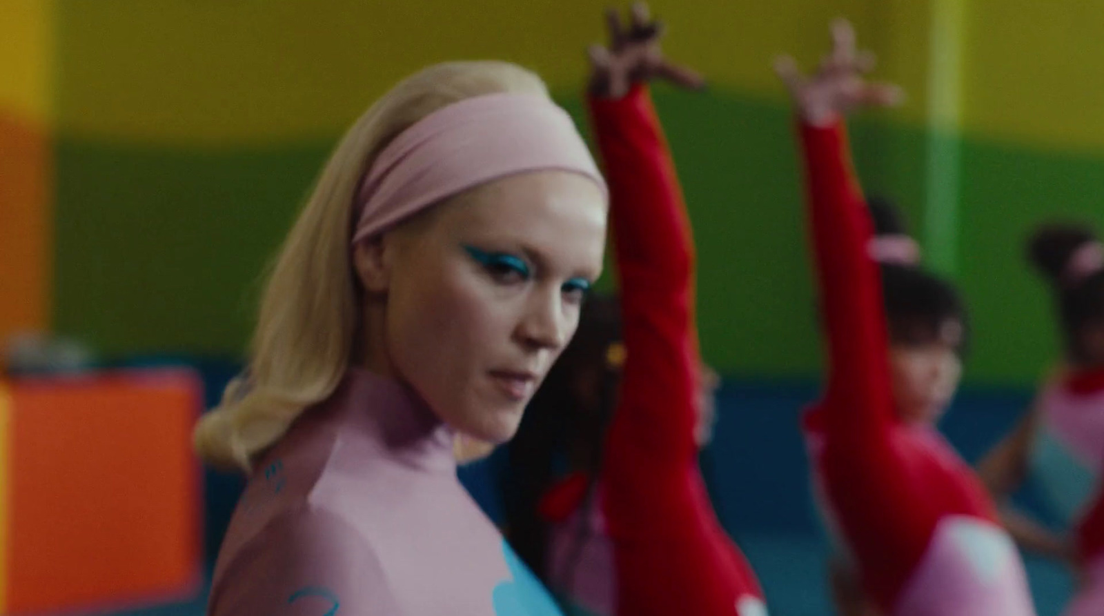 a group of women in pink and blue outfits