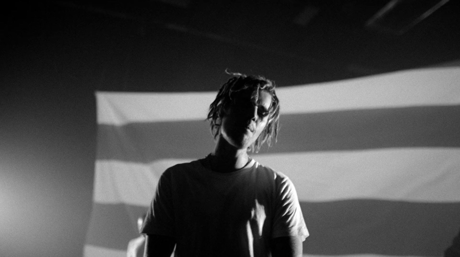 a man standing in front of a large american flag