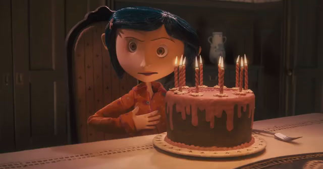 a girl sitting in front of a cake with candles on it