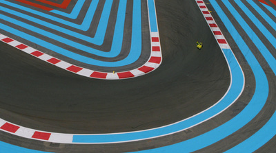 a person riding a skateboard on a race track