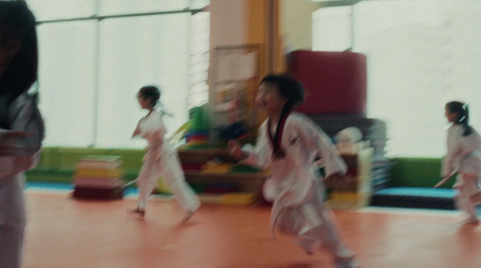 a group of young children in karate uniforms