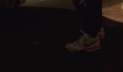 a person standing on a street corner at night