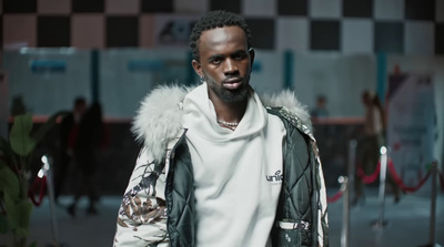 a man in a white shirt and a black and white jacket