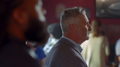 a man in a suit and tie standing in a room