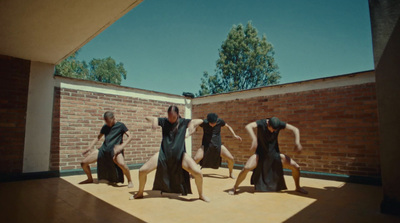 a group of women standing on top of a wooden floor