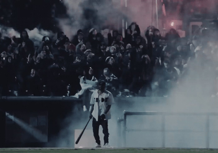 a man holding a baseball bat in front of a crowd