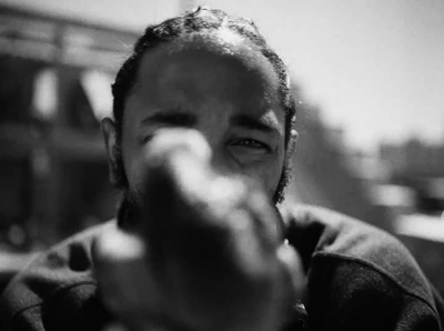 a black and white photo of a man pointing at the camera