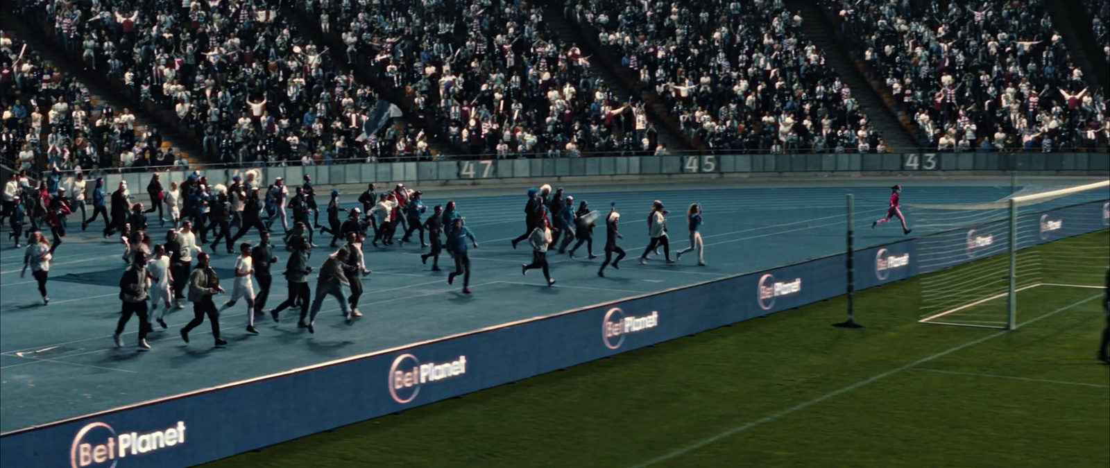 a group of people walking across a tennis court