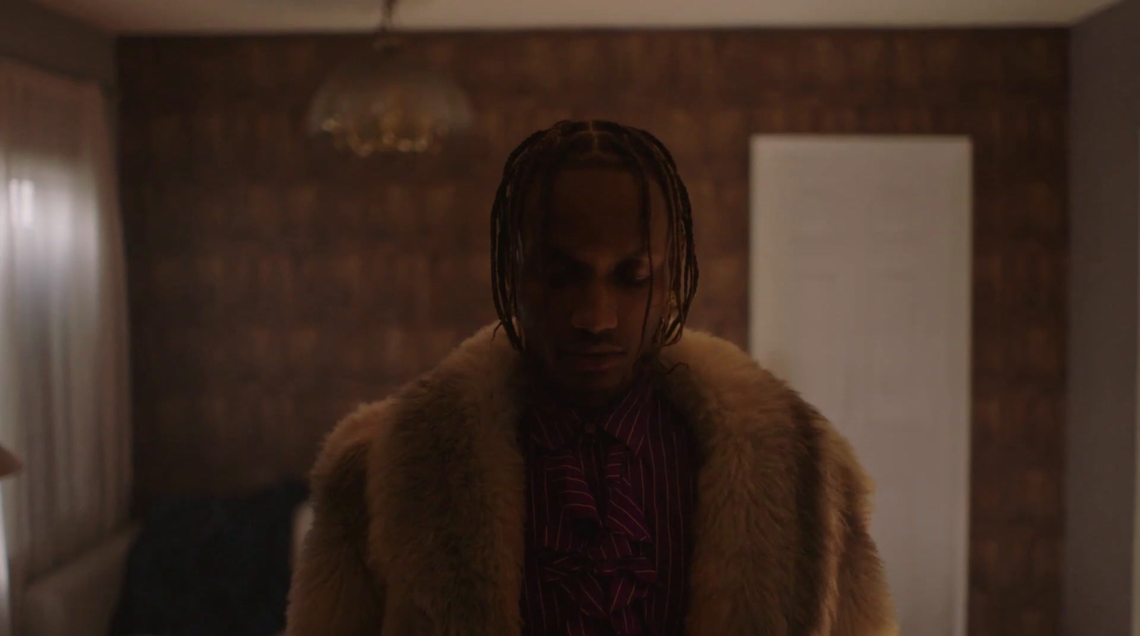 a man with dreadlocks standing in a room