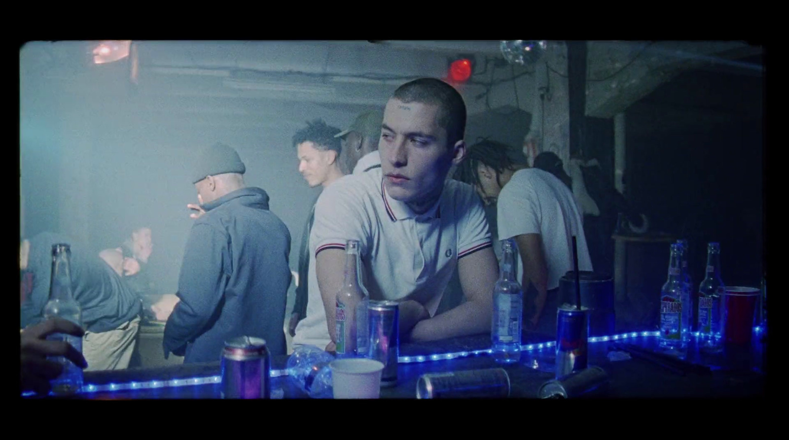 a group of people standing around a bar