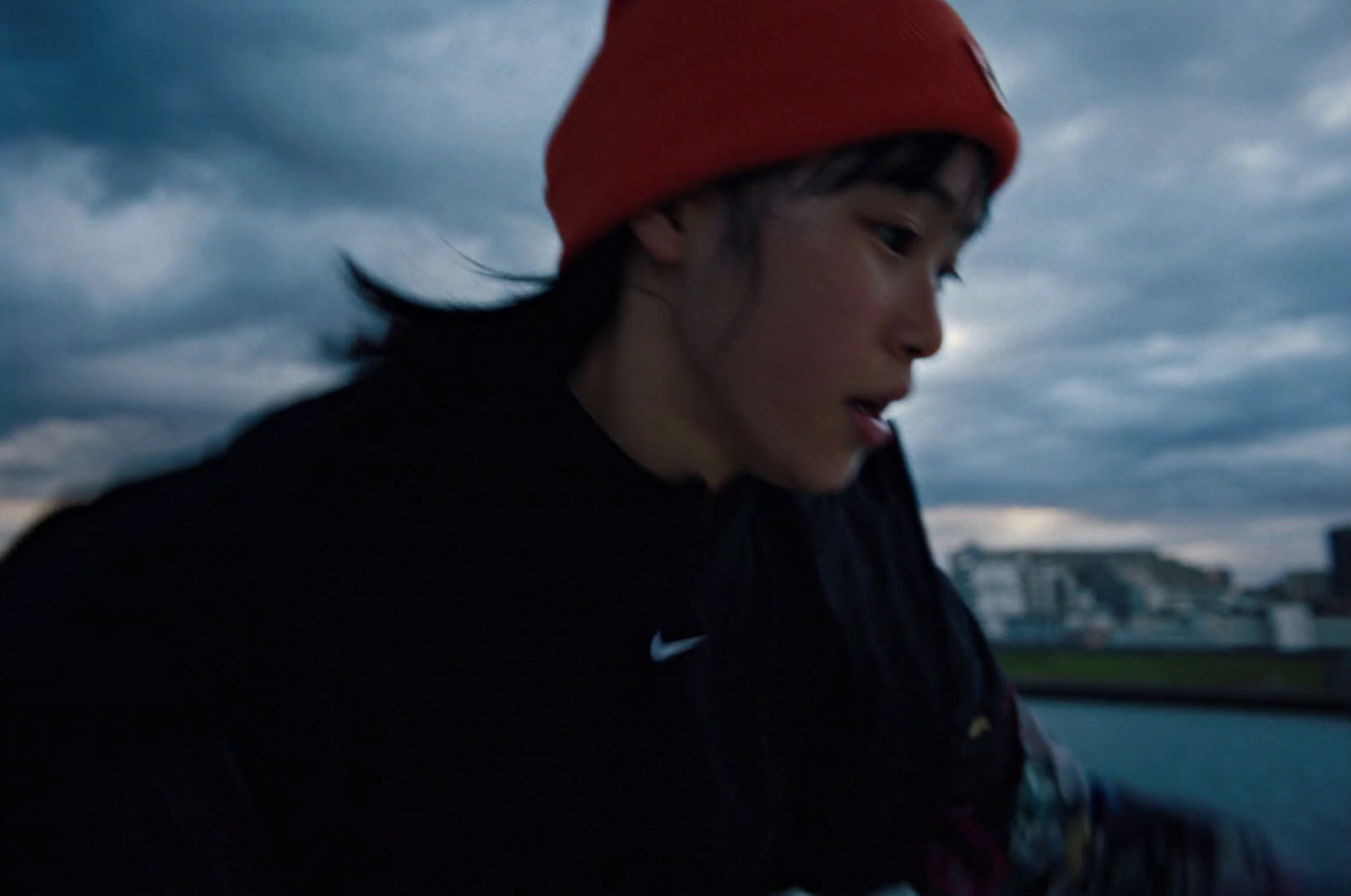 a young man wearing a red hat while holding a cell phone