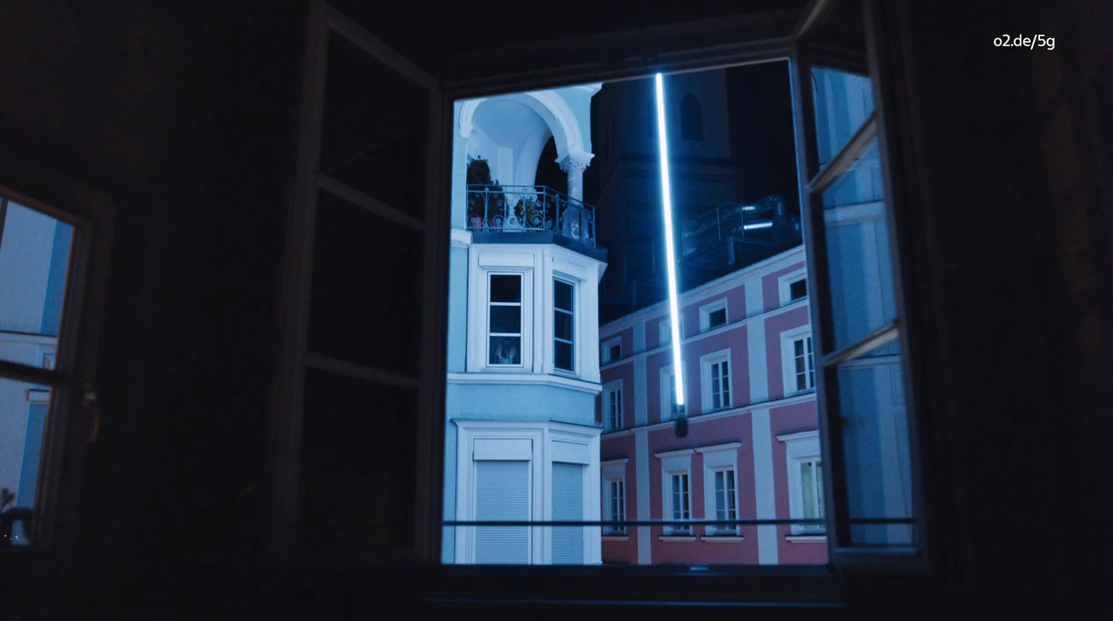 a view of a building through a window at night