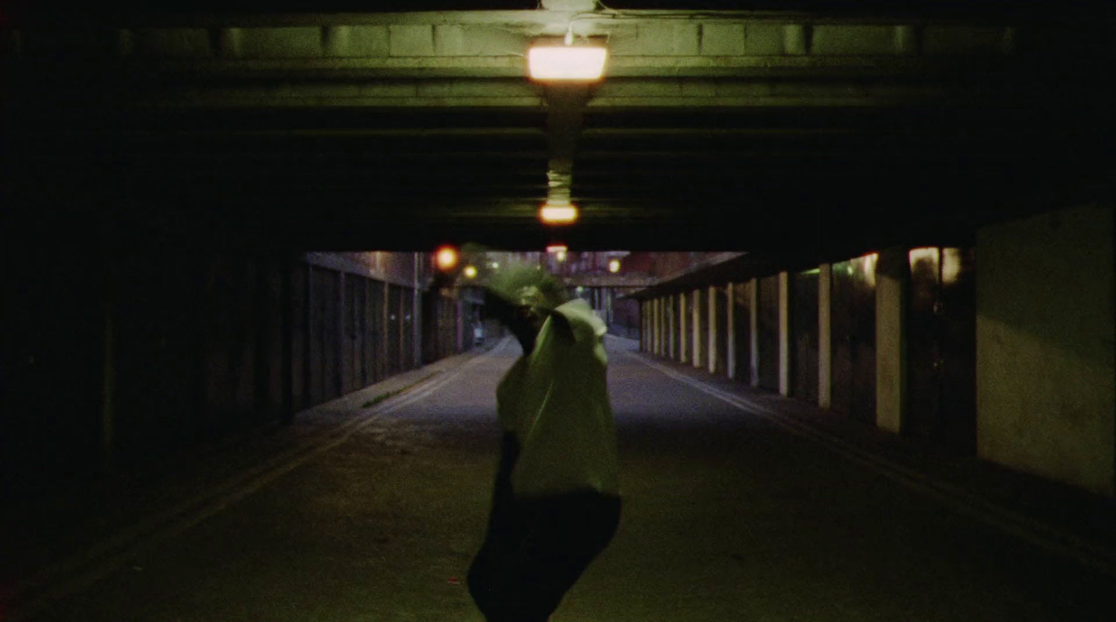 a person walking down a dark street at night