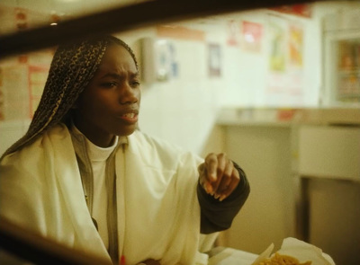 a woman sitting at a table with a plate of food