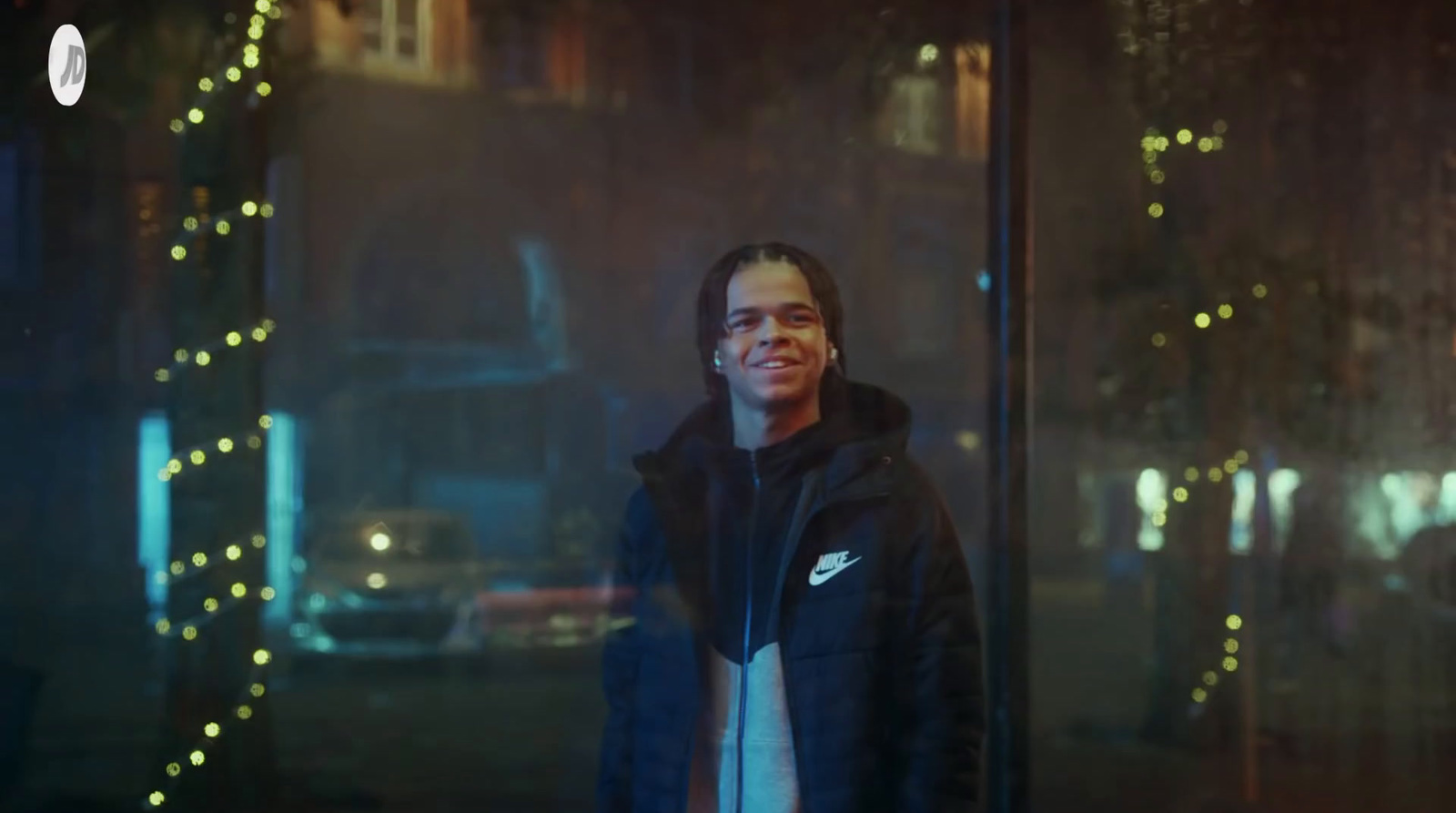 a man standing in front of a window at night