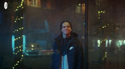 a man standing in front of a window at night