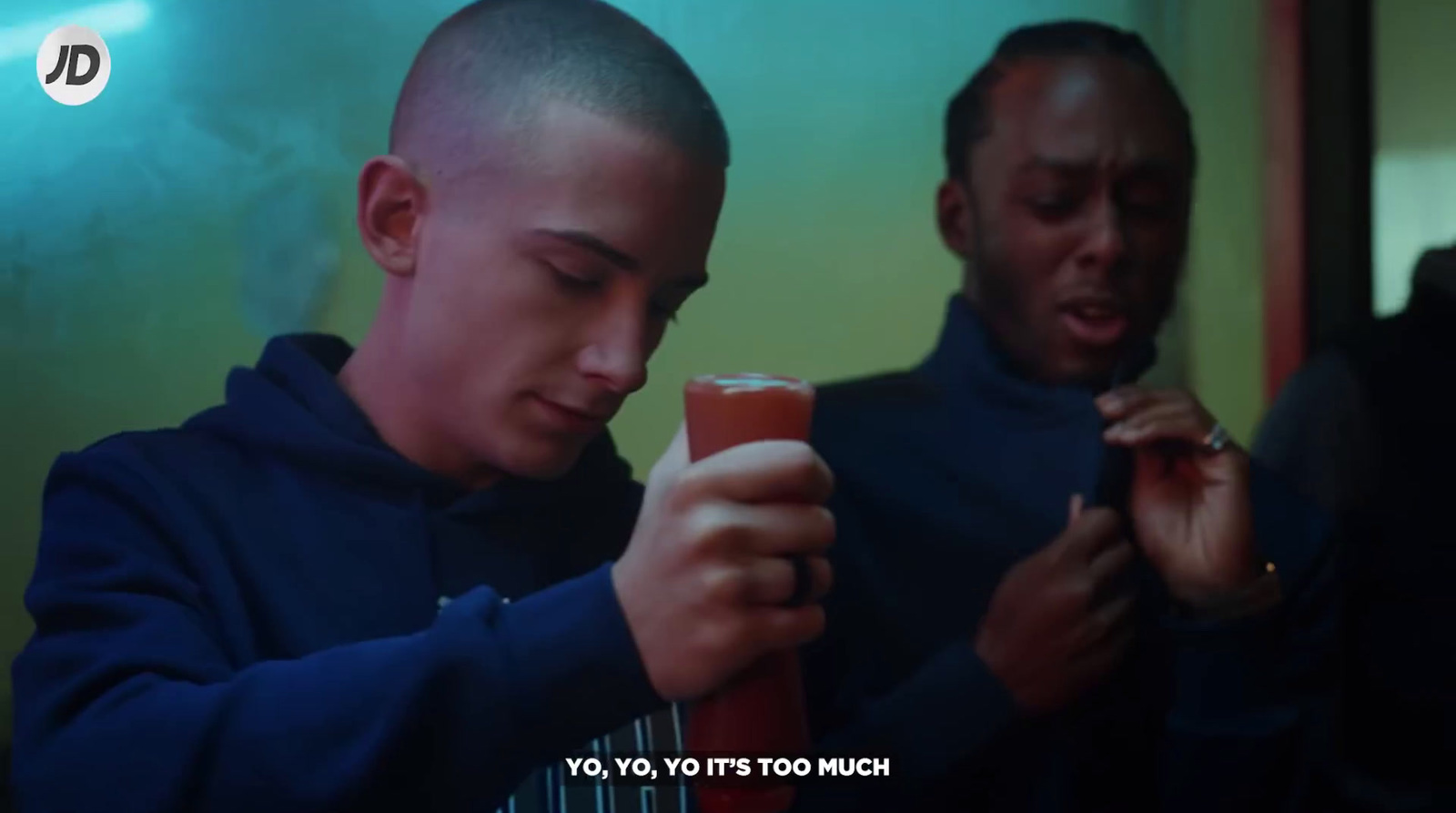 two men are looking at a cell phone